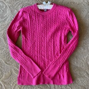 - Pink cable knit sweater.